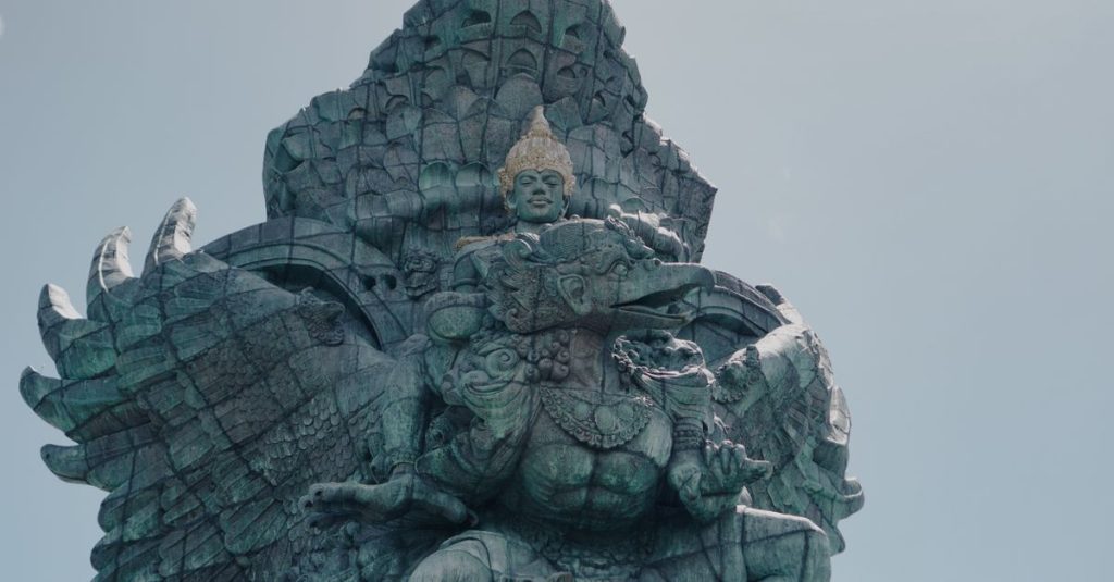 Majestic view of Garuda Wisnu Kencana statue in Bali under a clear blue sky.